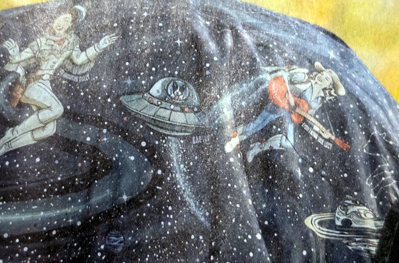 Close-up of the Cosmic Cowgirl print: astronaut cowgirls and a UFO